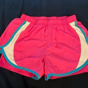 Medium size double layer neon pink sports short with white and blue stripes